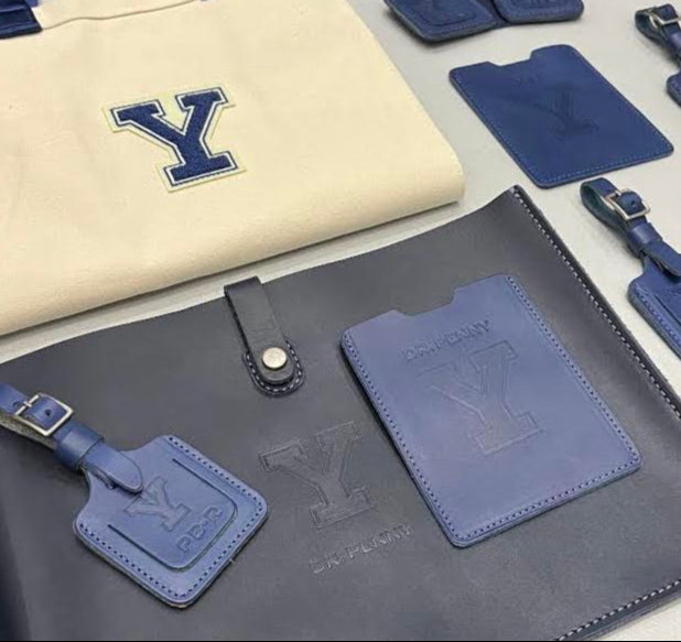 Collection of luggage tags and a bag with a visible 'Y' logo on a white surface.
