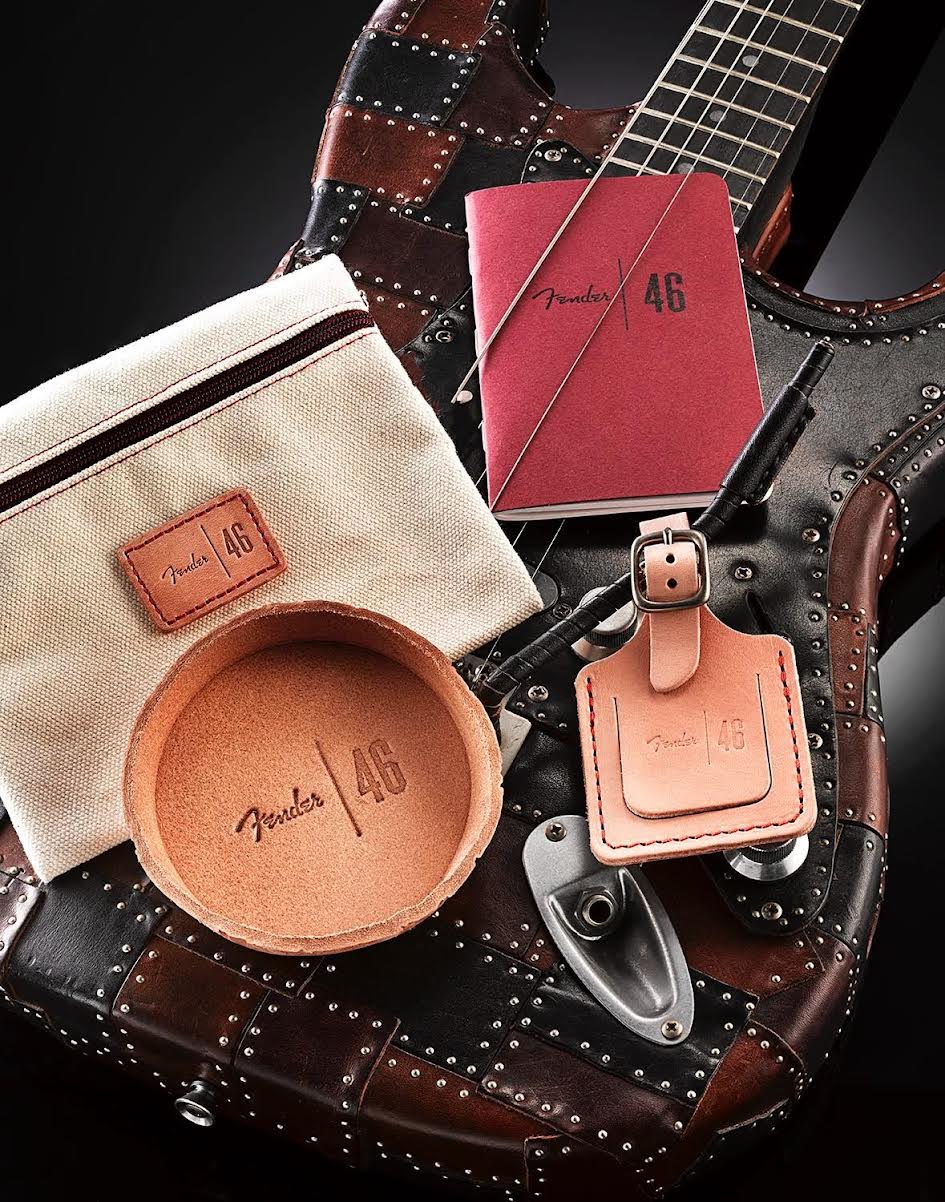 Collection of Fender-branded leather and canvas items on a guitar