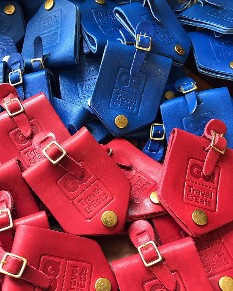 Collection of red and blue luggage tags with visible brand logo.