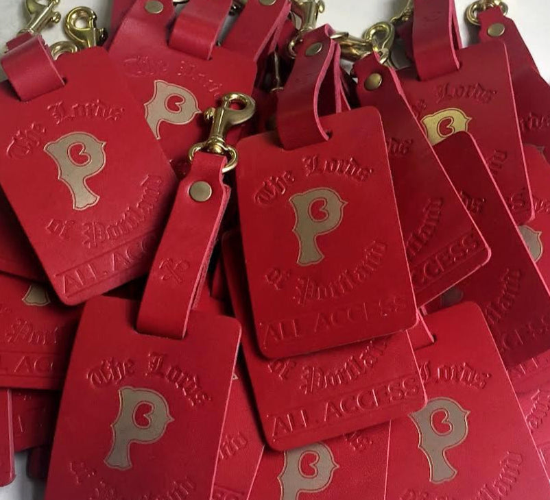 Red luggage tags with gold letter 'P' on a white background