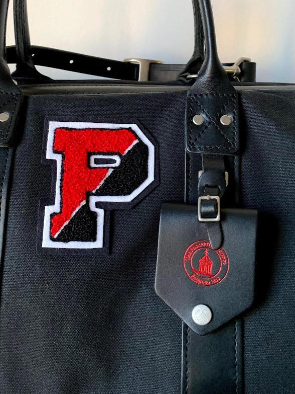 Black bag with a red and white 'P' patch on a light background