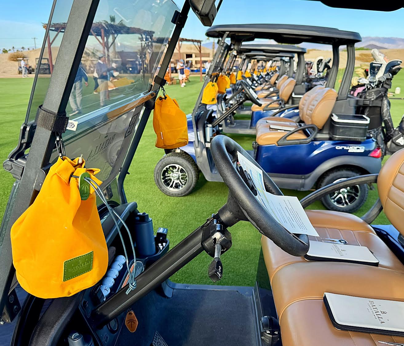 Golf carts with yellow bags on a golf course